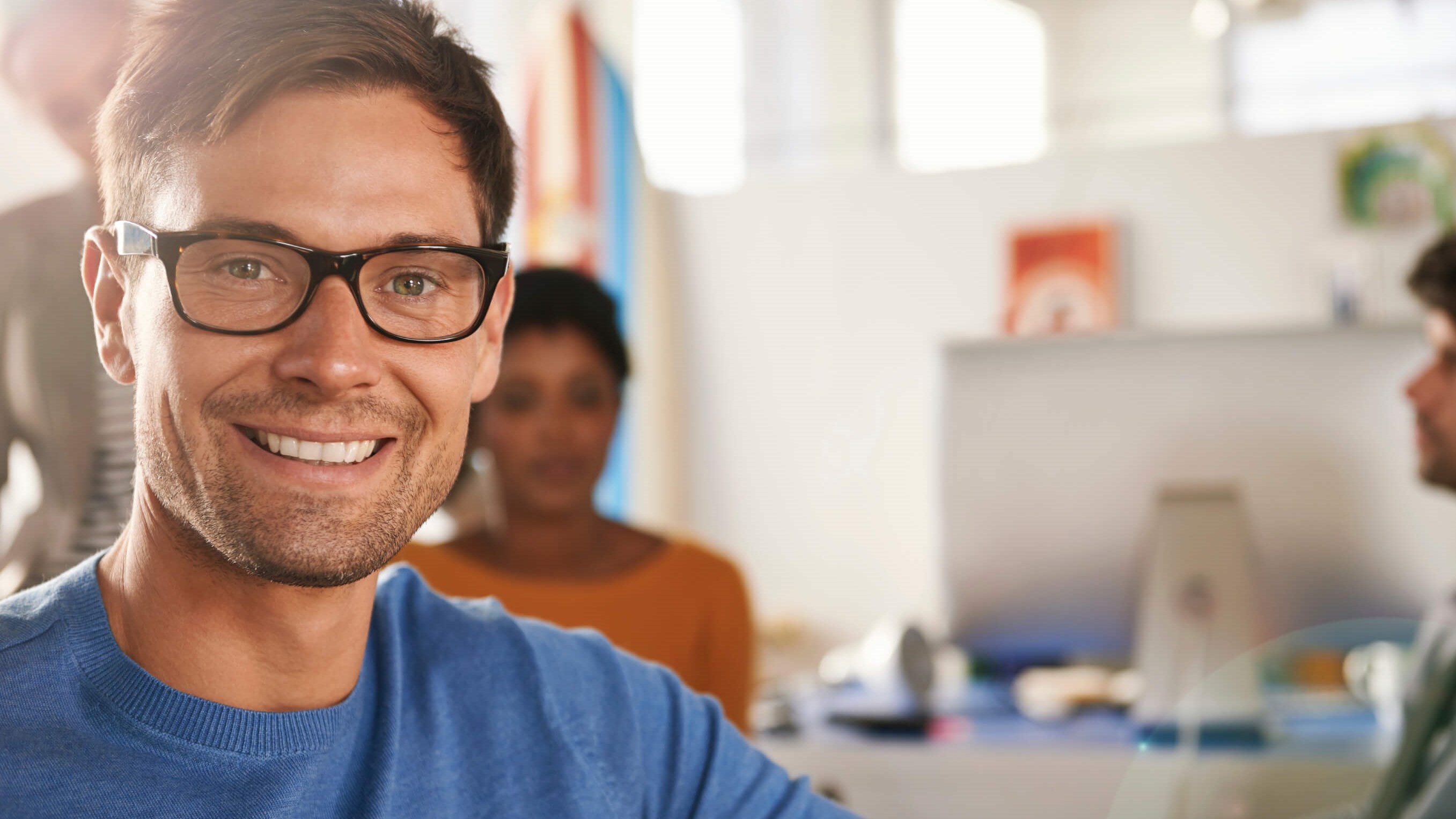 man in glasses smiling